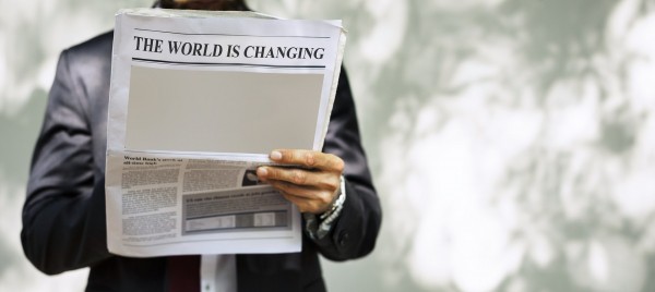 Businessman holds newspaper showing crisis headline